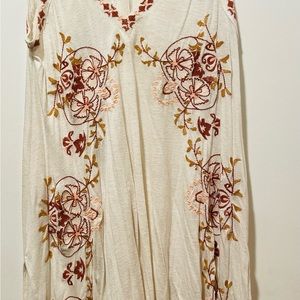 Flowy top or swimsuit coverup with embroidered details.